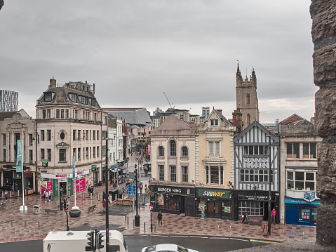 Cardiff, United Kingdom - September 16, 2018: Panoramic view of the city center streets of Cardiff, with people walking around in a cloudy day