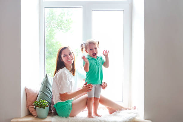 istock Young woman having fun with daughter 1043127680