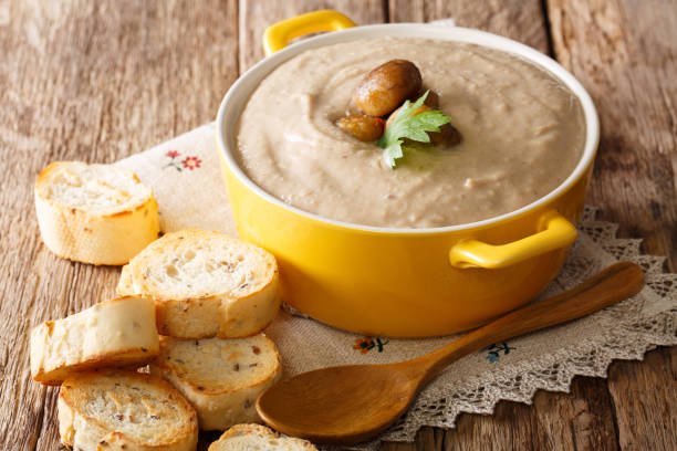 Delicate chestnut soup close-up in a saucepan and croutons. horizontal