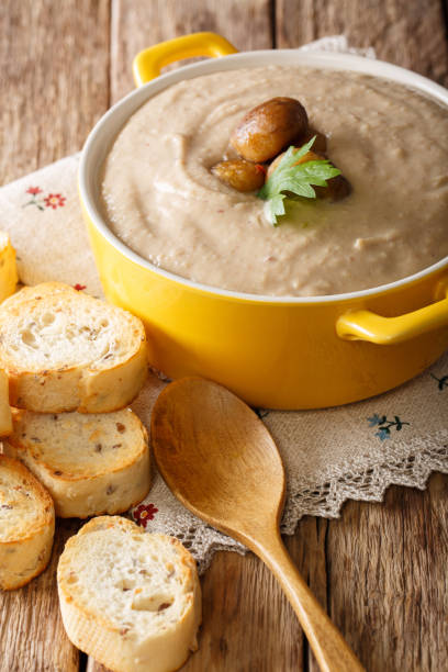 istock Soup puree from chestnuts close-up in a saucepan and croutons. vertical 1043128244