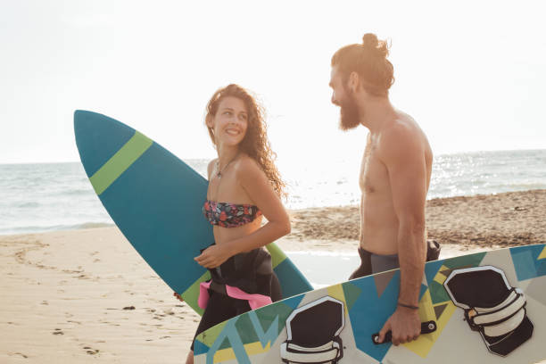 istock Man and woman holding surfing boards 1043131776