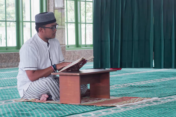 istock Southeast Asia Man Reading Al-Quran 1043132160