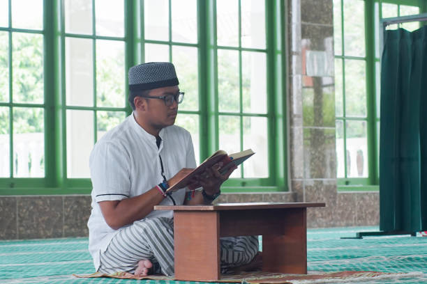 istock Southeast Asia Man Reading Al-Quran 1043132520