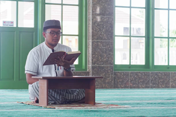istock Southeast Asia Man Reading Al-Quran 1043134878