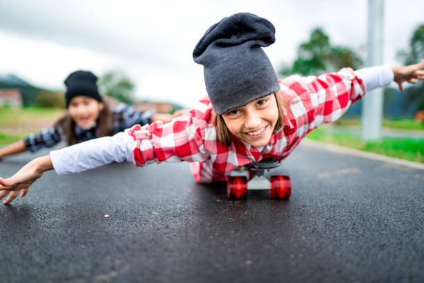 istock Little cool girls with skateboards 1043135308