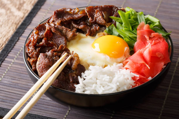 istock Japanese gyudon beef with rice, egg, ginger and onion close-up. horizontal 1043136010