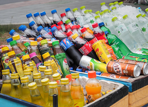 BANGKOK, THAILAND - June 24th, 2018 : Street vendor cart selling variety of cold energy drinks, soft drinks, bottled juice and sport drinks. Which are commonly seen in the streets of Bangkok. Thailand.