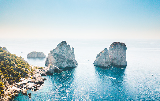 Rock formations in sea against sky.