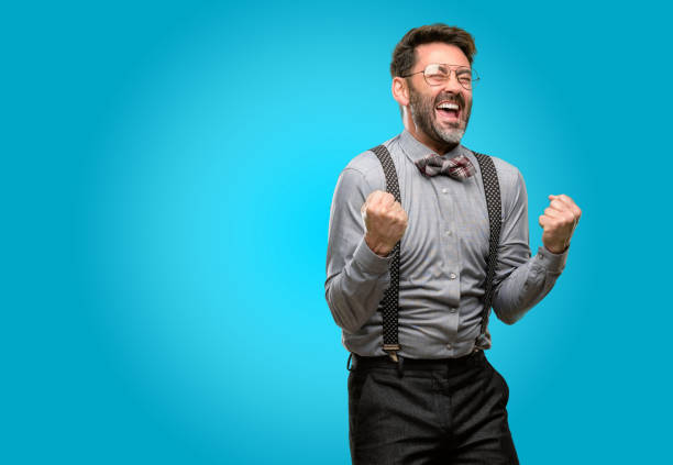 istock Middle age man, with beard and bow tie happy and excited expressing winning gesture. Successful and celebrating victory, triumphant 1043146538