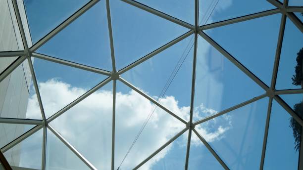 istock Blue sky and clouds through glass roof. 1043146662