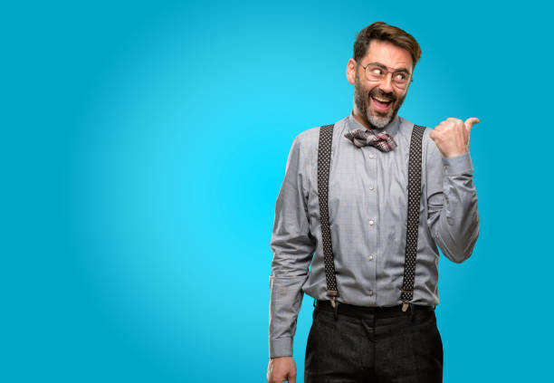 istock Middle age man, with beard and bow tie pointing away side with finger 1043146668