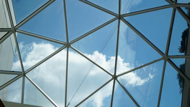 istock Blue sky and clouds through glass roof. 1043146670