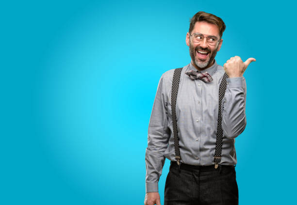 istock Middle age man, with beard and bow tie pointing away side with finger 1043146702