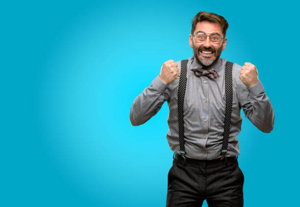 istock Middle age man, with beard and bow tie happy and excited expressing winning gesture. Successful and celebrating victory, triumphant 1043146706