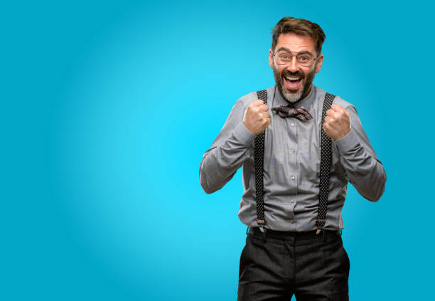 istock Middle age man, with beard and bow tie happy and excited expressing winning gesture. Successful and celebrating victory, triumphant 1043146752