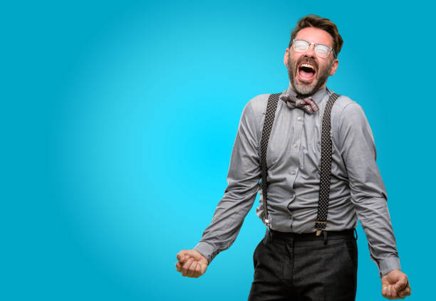 istock Middle age man, with beard and bow tie stressful, terrified in panic, shouting exasperated and frustrated. Unpleasant gesture. Annoying work drives me crazy 1043147530