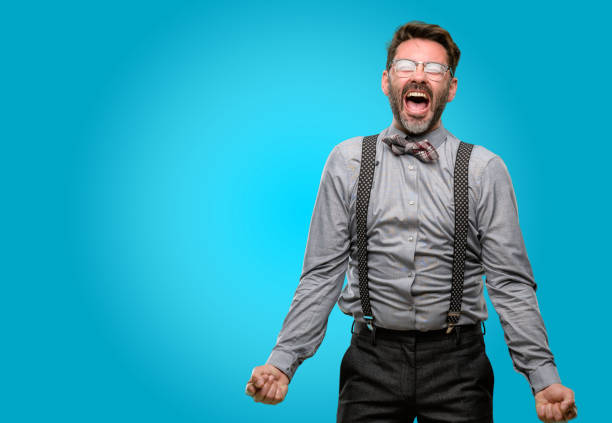 istock Middle age man, with beard and bow tie stressful, terrified in panic, shouting exasperated and frustrated. Unpleasant gesture. Annoying work drives me crazy 1043147538