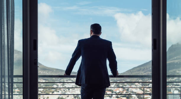 istock Businessman standing by hotel room balcony 1043148162