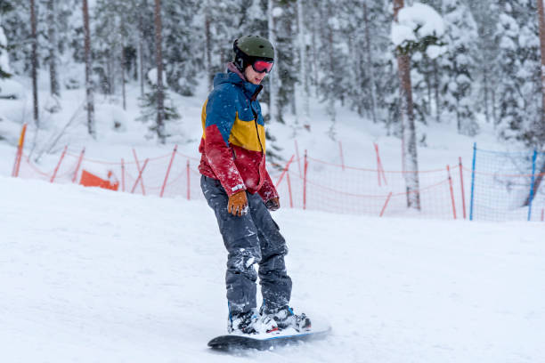 istock Young man snowboarding in snowfall 1043148168