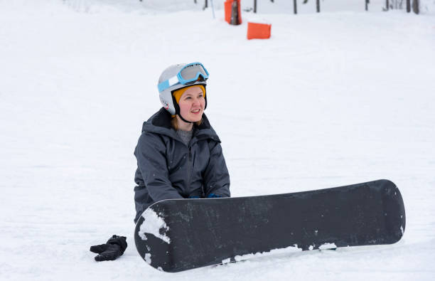 istock Girl snowboarding in snowfall 1043150378