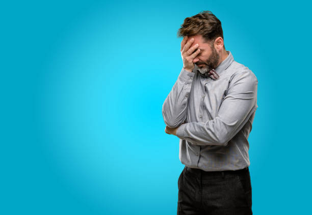 istock Middle age man, with beard and bow tie stressful keeping hands on head, tired and frustrated 1043150410