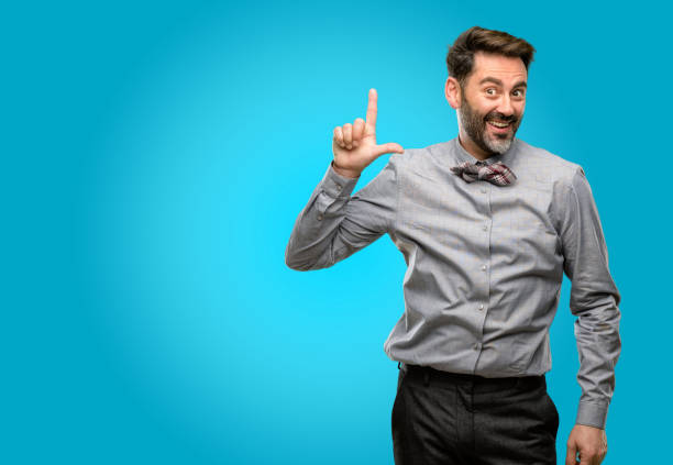 istock Middle age man, with beard and bow tie pointing away side with finger 1043152694