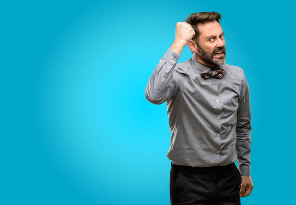 istock Middle age man, with beard and bow tie irritated and angry expressing negative emotion, annoyed with someone 1043152878