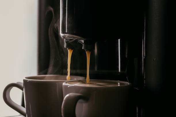 istock Fresh coffee prepared in the coffee machine. Espresso in small white cups. 1043153262