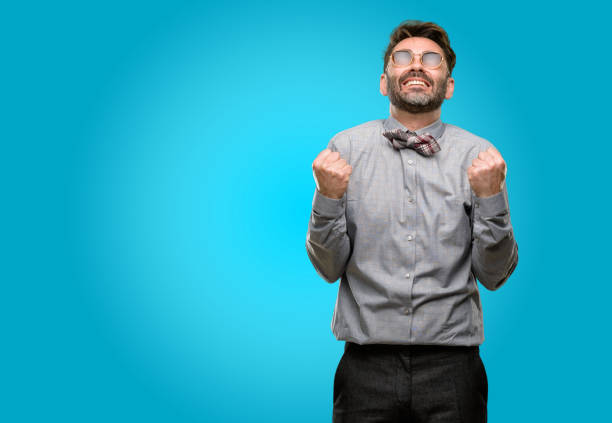 istock Middle age man, with beard and bow tie happy and excited celebrating victory expressing big success, power, energy and positive emotions. Celebrates new job joyful 1043153466