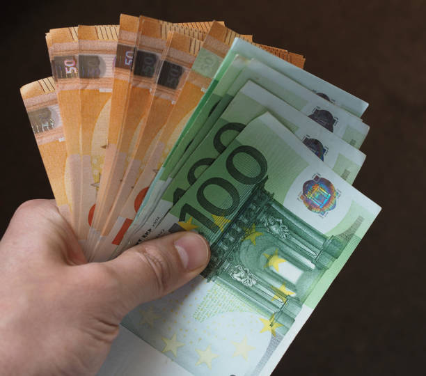 istock Hand with Euro notes, European Union 1043156328