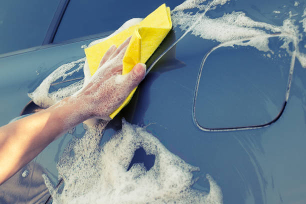 istock Car washing with a yellow sponge 1043158606