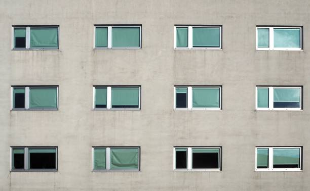 istock Gray modern building facade with new  pvc windows. Front view, detail 1043160702