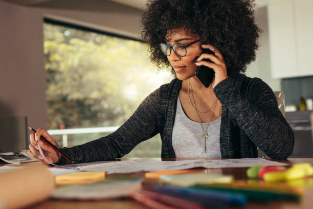 istock Businesswoman talking on smartphone and working in office 1043161704