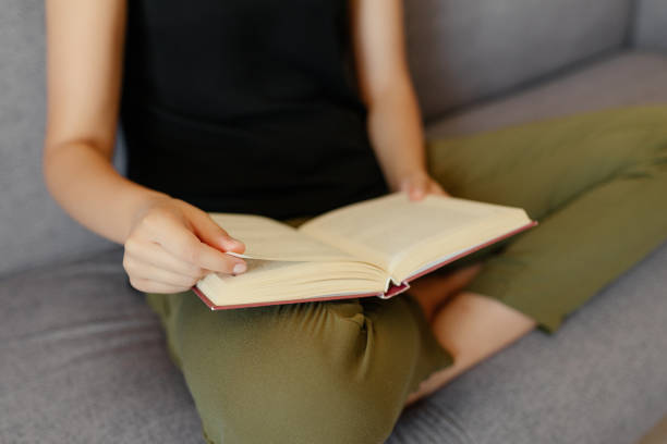 istock Close-up view of woman reading a book 1043165166