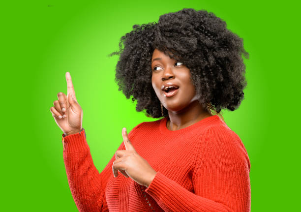 istock happy and surprised cheering expressing wow gesture pointing up 1043165286