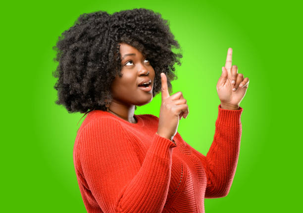 istock happy and surprised cheering expressing wow gesture pointing up 1043165312