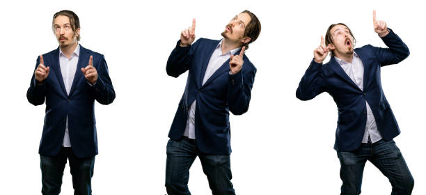 istock Handsome young man happy and surprised cheering expressing wow gesture pointing up 1043165926