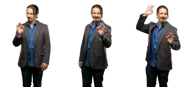 istock Handsome young man doing ok sign with hand, approve gesture 1043166030