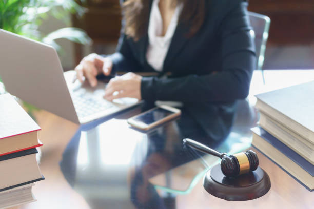 istock Judge gavel and lawyer working on a laptop. Selective focus 1043166626
