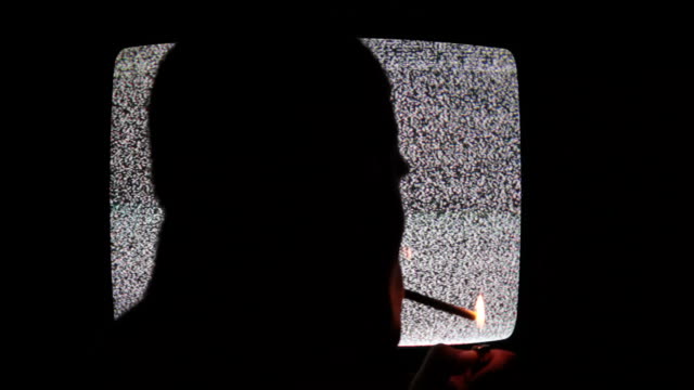 Man Smoking Before Tv screen