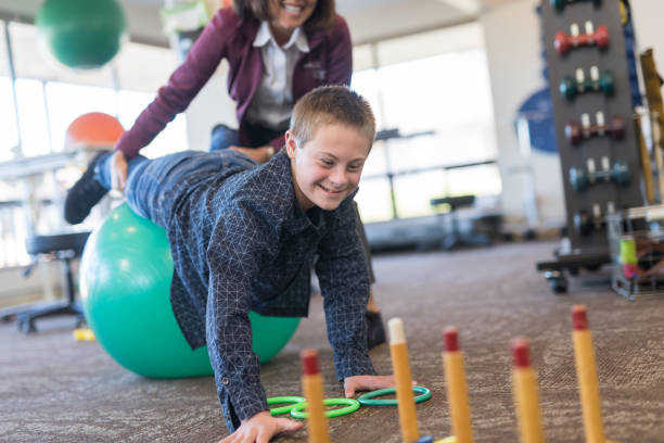 istock A boy does workouts with an occupational therapist at a physiotherapy clinic 1043169150