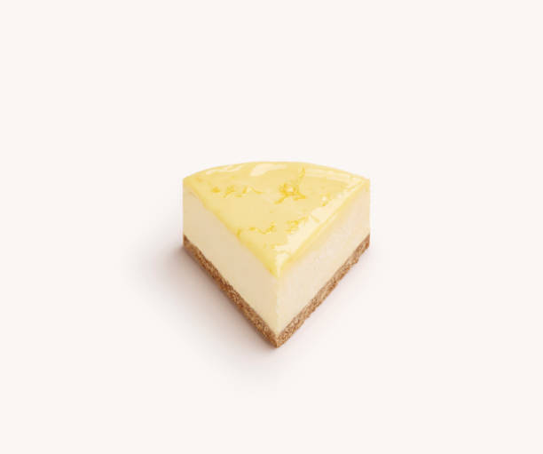 Lemon Cheesecake Isolated piece of lemon cake on a white background fruit garnish stock pictures, royalty-free photos & images