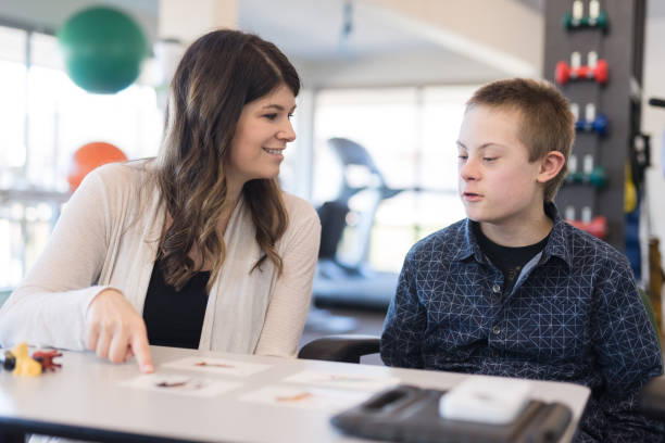 istock Speech therapist works with a young boy 1043169450