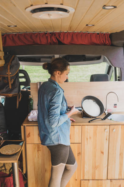 istock Woman cooking pancakes  in camper van 1043169550