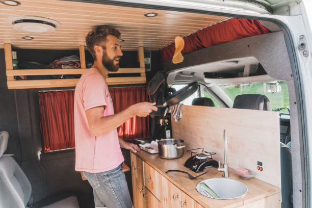 istock Man cooking pancakes  in camper van 1043169554