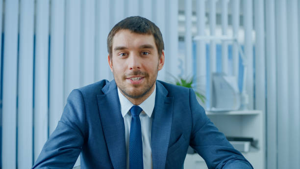 istock Handsome Respectable Businessman Sitting at His Desk in Office, Looking into the Camera. 1043174818