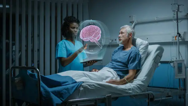 In the Hospital, Senior Patient Lying in the Bed Nurse Holding Tablet Computer Shows Augmented Reality Brain Scan. In the Technologically Advanced Hospital Ward.