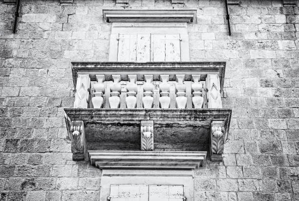 Balcony on the old house, Trogir, Croatia. Travel destination. Architectural theme. Black and white photo.