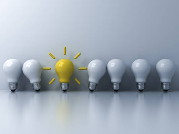 istock Think different concept One yellow idea light bulb standing out from the white unlit bulbs with window reflections and shadows leadership and individuality creative idea concepts 3D rendering 1043175148