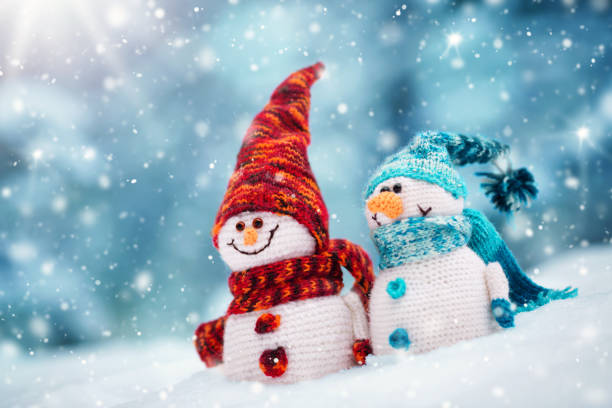 istock little snowmans on soft snow on blue background 1043175340